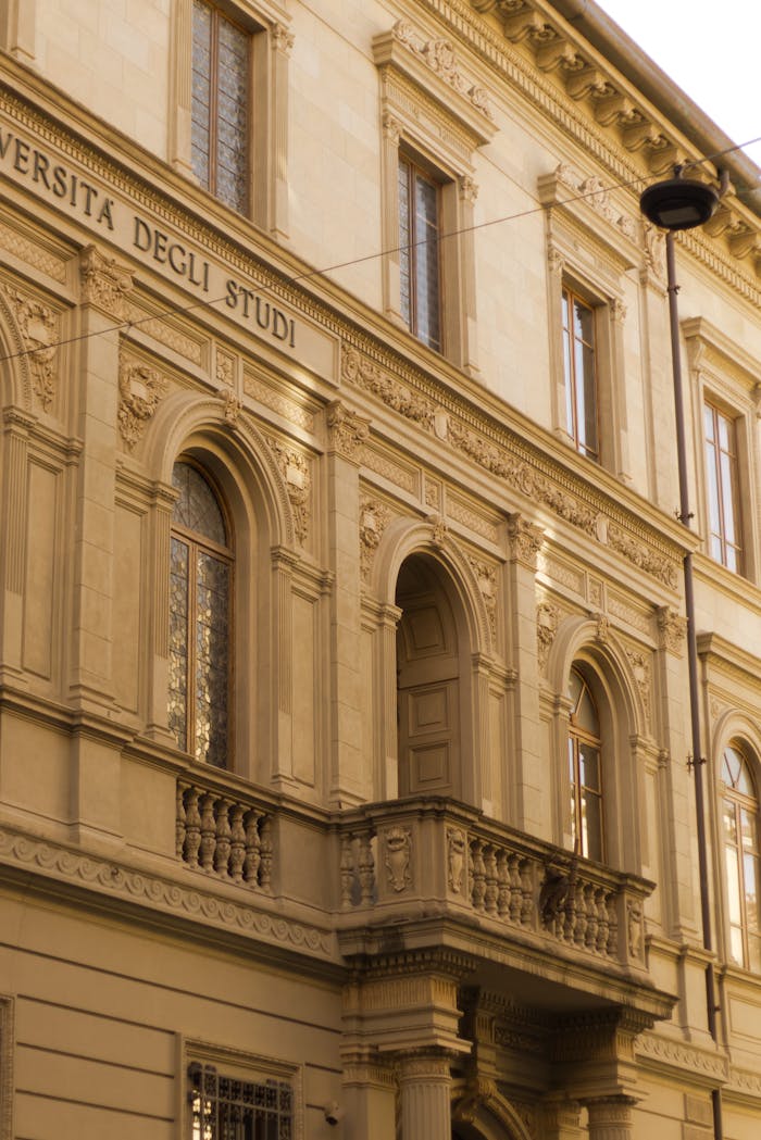ours-journey Elegant historic architecture of university building in Pisa, Italy, showcasing classic design.